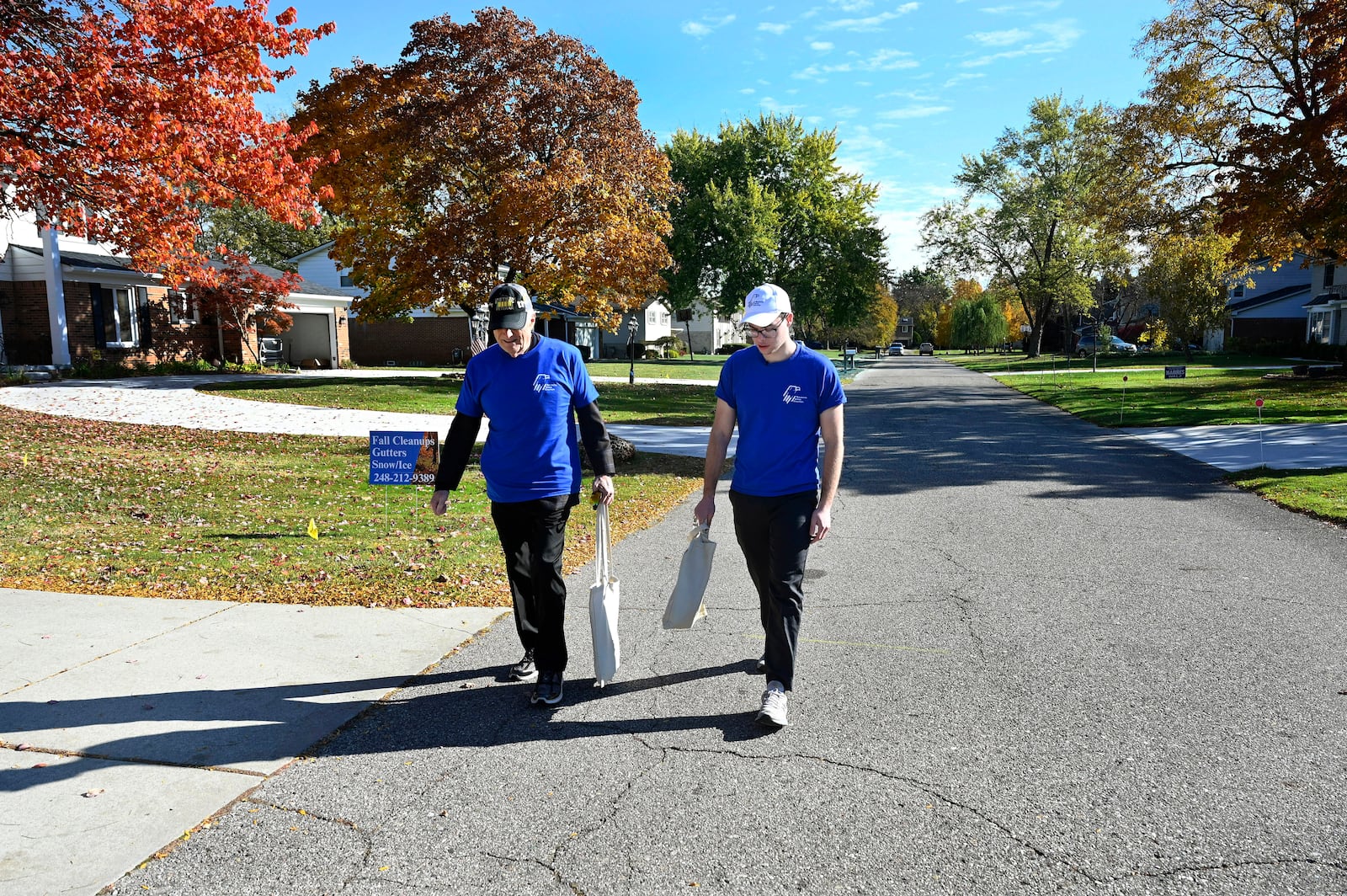 Republican Jewish Coalition members David Cuttner, left, and Noam Nedivi canvass a neighborhood, Sunday, Oct. 27, 2024, in West Bloomfield Township, Mich. (AP Photo/Jose Juarez)