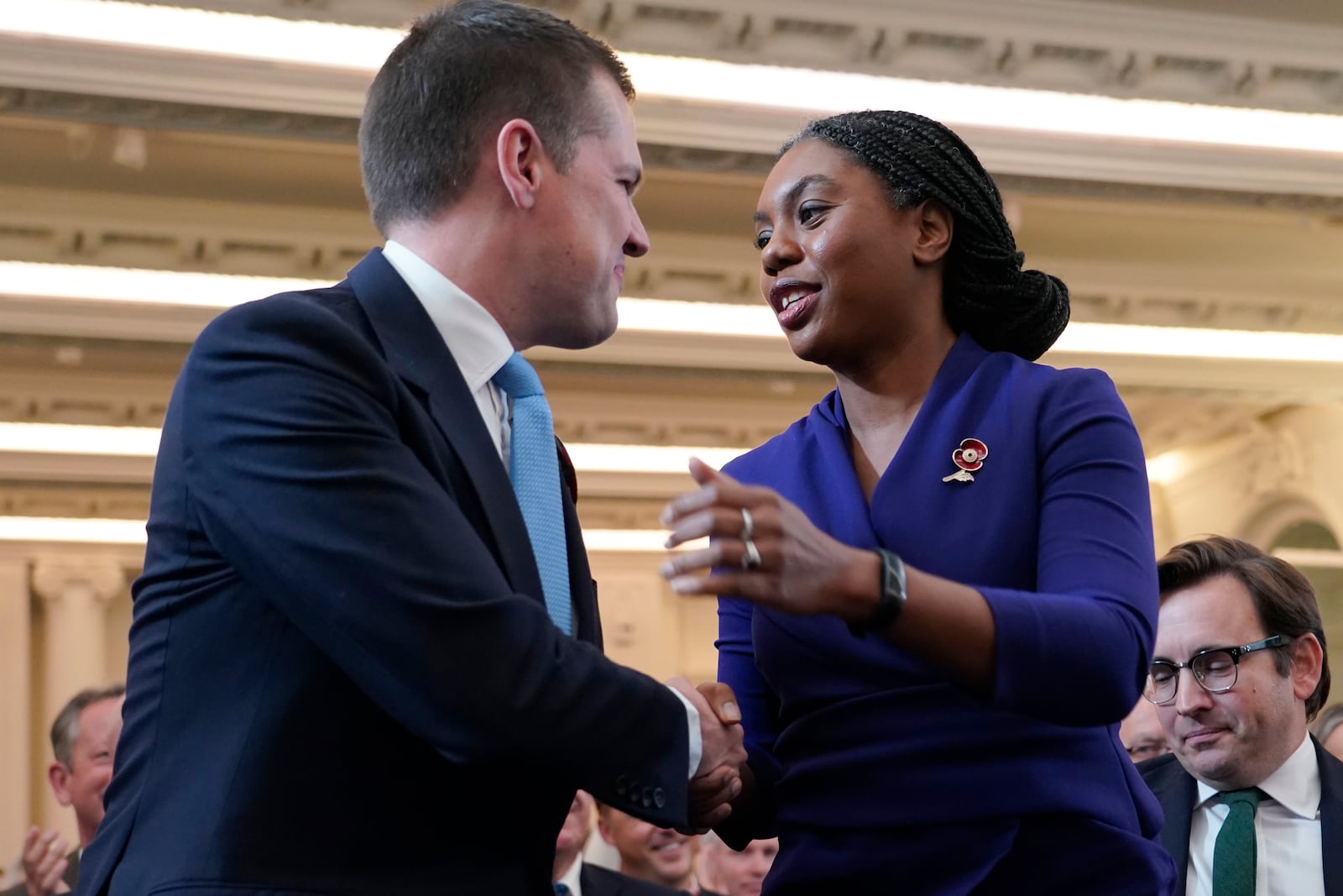 Britain's Member of Parliament Kemi Badenoch right, shakes hands with losing candidate Robert Jenrick, left, after being elected as the new leader of the opposition Conservative Party, in London, Saturday, Nov. 2, 2024.(AP Photo/Alberto Pezzali)