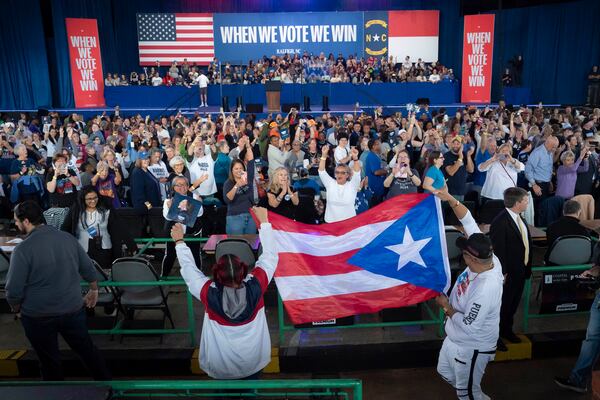 Supporters carry the Puerto Rican flag before Democratic presidential nominee Vice President Kamala Harris arrives to speak at a campaign rally, Wednesday, Oct. 30, 2024, in Raleigh, N.C. (AP Photo/Allison Joyce)