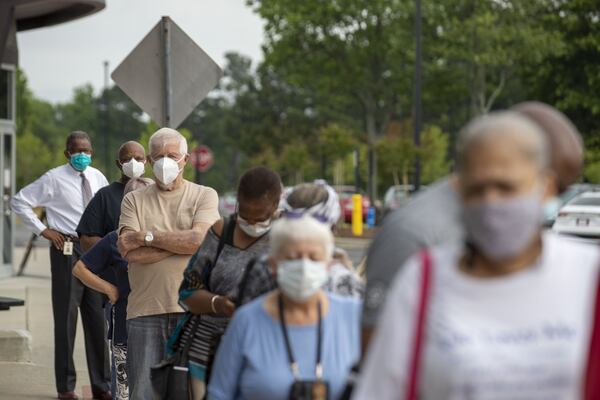 Voters wearing face masks strand in line outside of the Gwinnett County Voter Registration and Elections Office in order to participate in early voting in Lawrenceville, Monday, May 18, 2020. Early voting began May 18 and will last three-weeks, ended June 5. Georgia’s Election Day is Tuesday, June 9. ALYSSA POINTER / ALYSSA.POINTER@AJC.COM