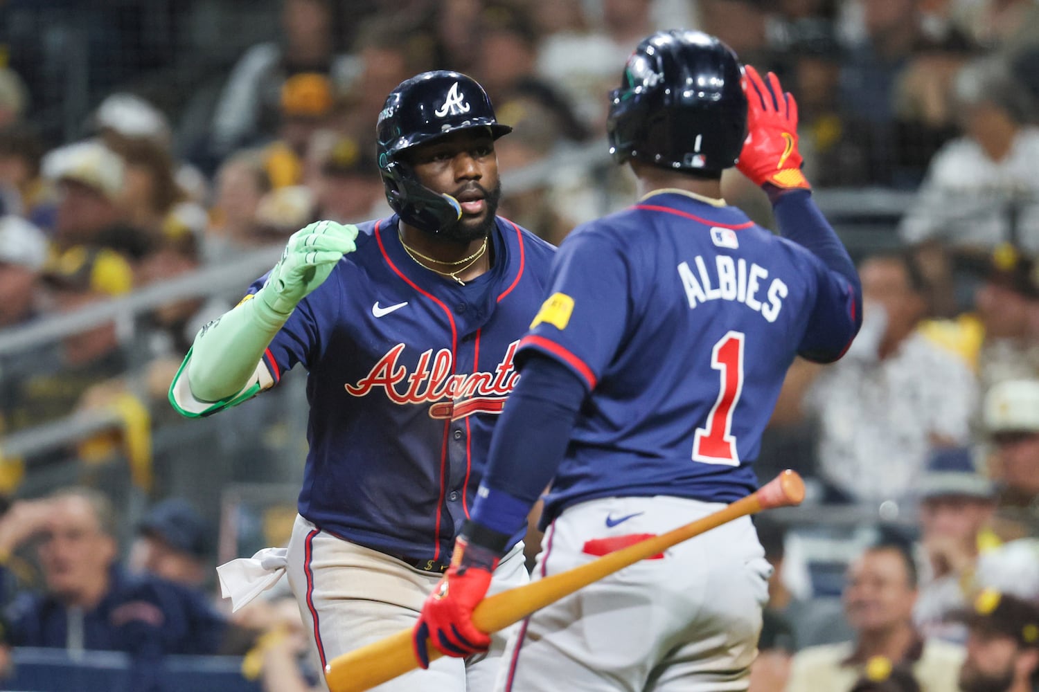 Atlanta Braves’ Michael Harris is greeted by Ozzie Albies (1) after a 2-RBI home run against the San Diego Padres during the eighth inning of National League Division Series Wild Card Game Two at Petco Park in San Diego on Wednesday, Oct. 2, 2024.   (Jason Getz / Jason.Getz@ajc.com)