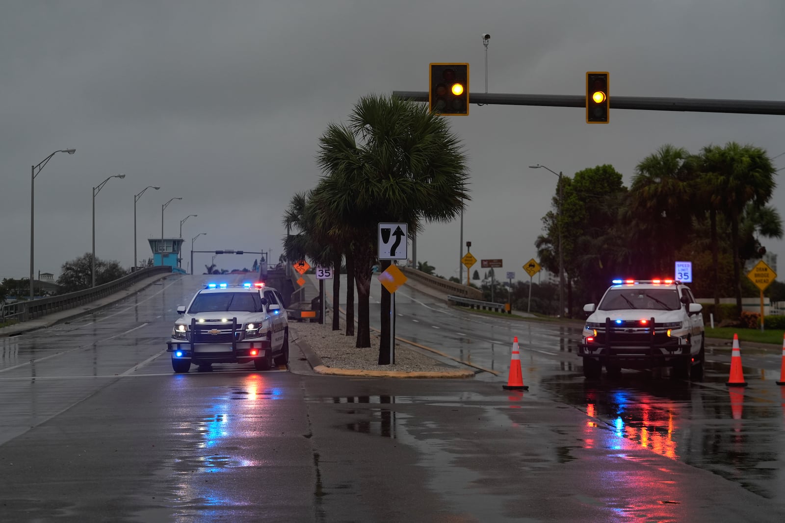 Police block off a bridge leading to the barrier island of St. Pete Beach, Fla., ahead of the arrival of Hurricane Milton, in South Pasadena, Fla., Wednesday, Oct. 9, 2024. (AP Photo/Rebecca Blackwell)