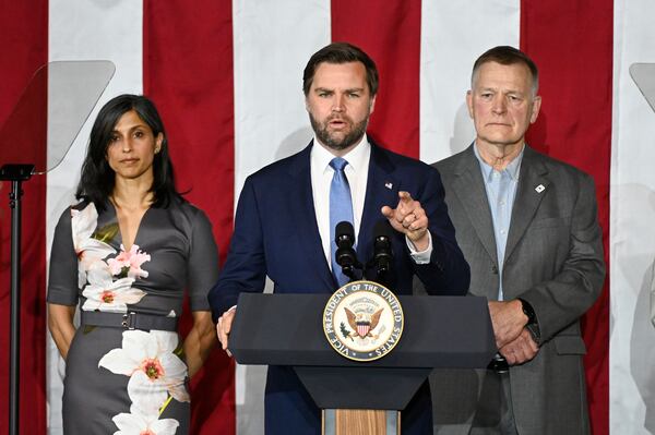 Vice President JD Vance, center, speaks at a rally about "America's industrial resurgence," as he is flanked by his wife, Usha Vance, left, and Vantage Plastics President Paul Aultman, Friday, March 14, 2025, at Vantage Plastics in Bay City, Mich. (AP Photo/Jose Juarez)