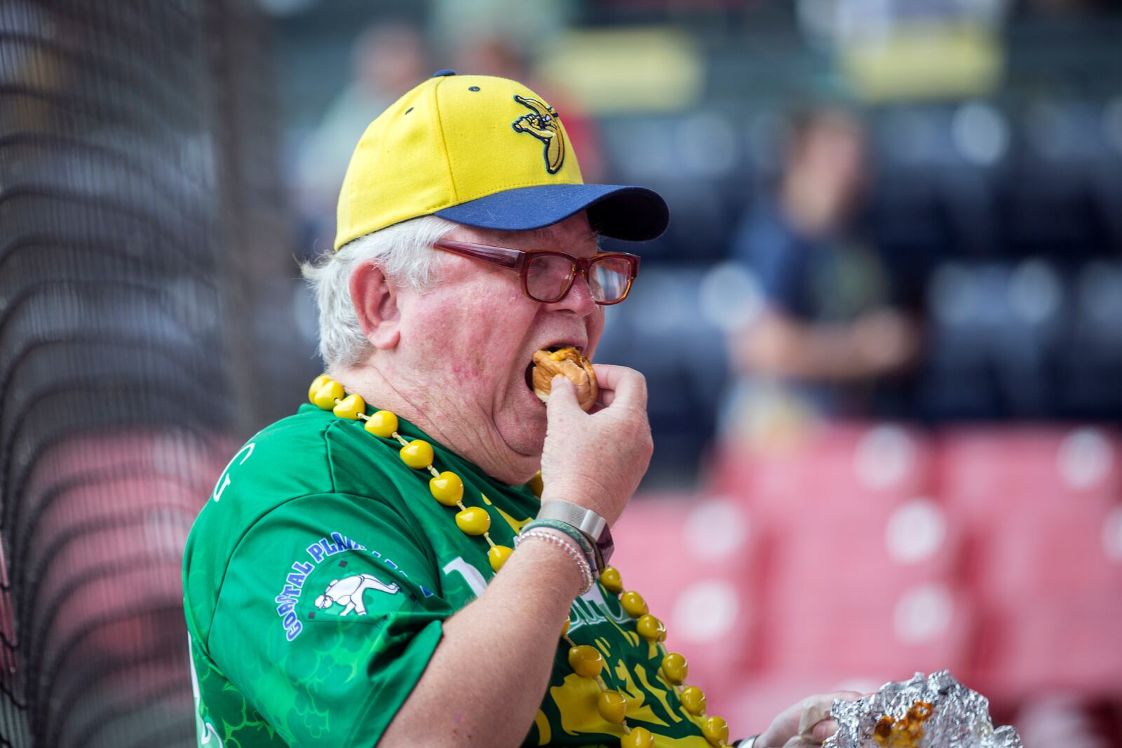 SAVANNAH, GA - JULY 12, 2022: Rick Ellison, of Savannah, enjoys a meal that comes with his ticket before the start of a Savannah Bananas game with the Holly Springs Salamanders at Historic Grayson Stadium. All fans get a free food with their ticket. (AJC Photo/Stephen B. Morton)