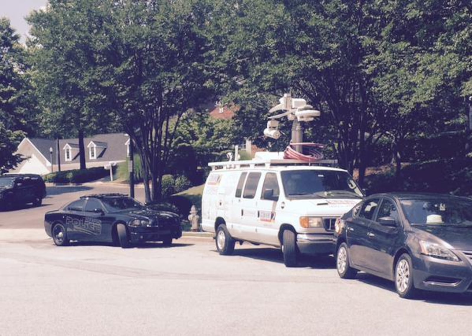 Media and police vehicle outside the hospice.