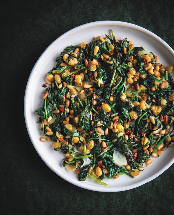 Don’t let the short ingredient list and lightning-quick prep work deceive you: Sauteed Spinach with Golden Raisins and Pine Nuts delivers surprising pops of complex flavor and crunch that make this Technicolor side dish the star of the show. From “Everyone’s Table” by Gregory Gourdet and JJ Goode (Harper Wave, $37.50). (Courtesy of Eva Kosmas Flores)