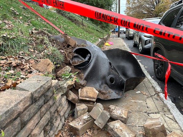 A large metal piece of debris that was flung across a street by a blast at a Louisville, Ky, plant is shown on Wednesday, Nov. 13, 2024. Two workers died in the explosion at the Givaudan Color Sense plant in Louisville. (AP Photo/Dylan Lovan)