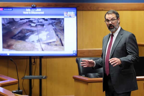 Jason McLarry, attorney for Troutman Pepper Locke, discusses an image of the sinkhole at the Piedmont Park Community Center as he delivers the opening statements on the defense side representing the Piedmont Park Conservancy against the Nook restaurant at the courtroom of judge Scott McAfee in the Fulton County Courthouse on Tuesday in Atlanta. Jason Getz/AJC