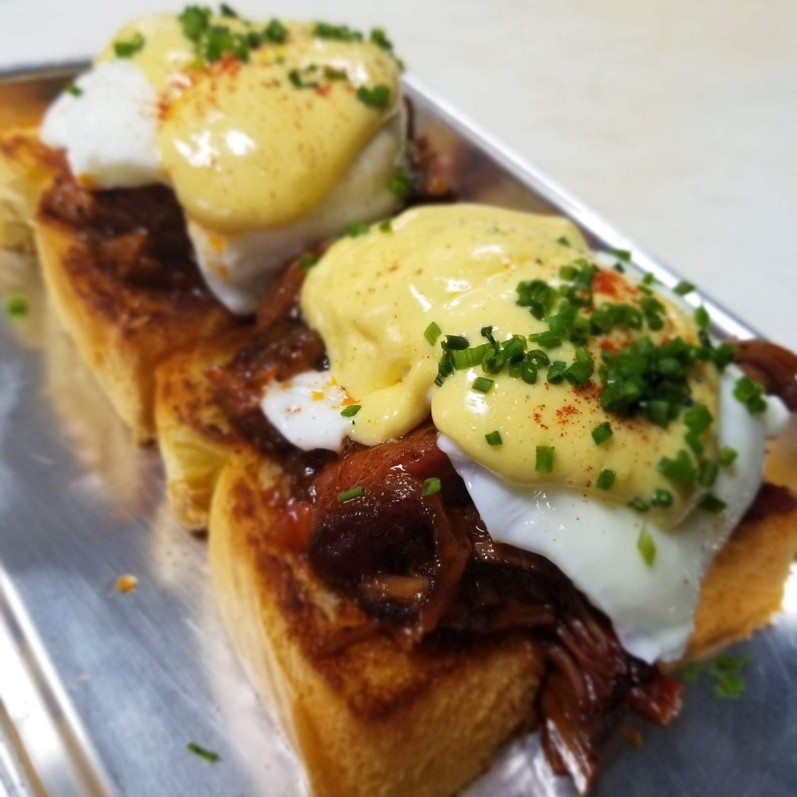 The Brisket Bennie, an eggs Benedict riff made with the chef’s smoky-sweet barbecue, is a brunch highlight at the Little Farmhouse Cafe. CONTRIBUTED BY THE LITTLE FARMHOUSE CAFE