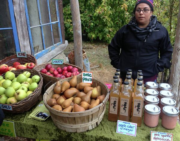 Stacy Torres staffs a sale table at Fruit City Farms on Lopez Island.  (Brian J. Cantwell /Seattle Times/TNS)