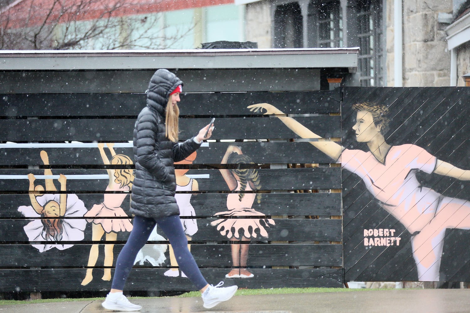 A person takes a walk as light snow falls in Piedmont Park on Sunday, Jan. 16th, 2022, in Atlanta. Miguel Martinez for The Atlanta Journal-Constitution