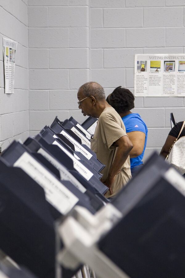 A man casts his vote during Saturday early voting at the C.T. Martin Natatorium and Recreation Center in Atlanta. (REANN HUBER/REANN.HUBER@AJC.COM)