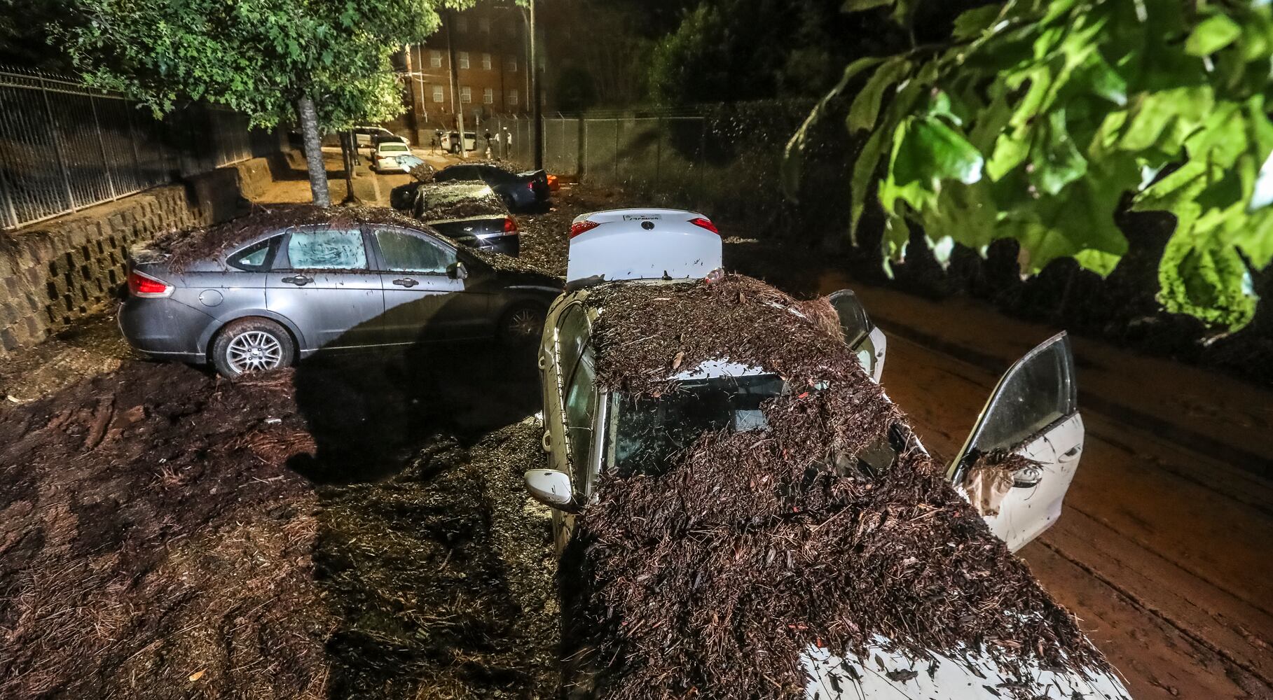 September 15, 2023 Atlanta: Along Parsons Street near Lawshe Street through Clark Atlanta University, so much mud was left behind that it looked like a dirt road as flooded cars remained after the water receded Friday morning, Sept. 15, 2023. Channel 2 meteorologist Brian Monahan said the storm parked over the city, dropping so much rain so quickly in an area predominantly covered in pavement, and the water simply had nowhere to go. Strong and quick-moving thunderstorms plowed through downtown Atlanta on Thursday afternoon, flooding roads, impacting college students and prompting the evacuation of one of the city’s premier attractions. According to city officials, rain gauges show that about three hours’ worth of rain came down in just 15 minutes in some areas of downtown Atlanta. (John Spink / John.Spink@ajc.com)

