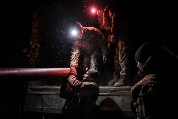 In this photo provided by Ukraine's 24th Mechanized Brigade press service, servicemen get an MRLS BM-21 "Grad" ready to fire towards Russian army positions near Chasiv Yar, Donetsk region, Ukraine, Sunday, Feb. 23, 2025. (Oleg Petrasiuk/Ukraine's 24th Mechanized Brigade via AP)