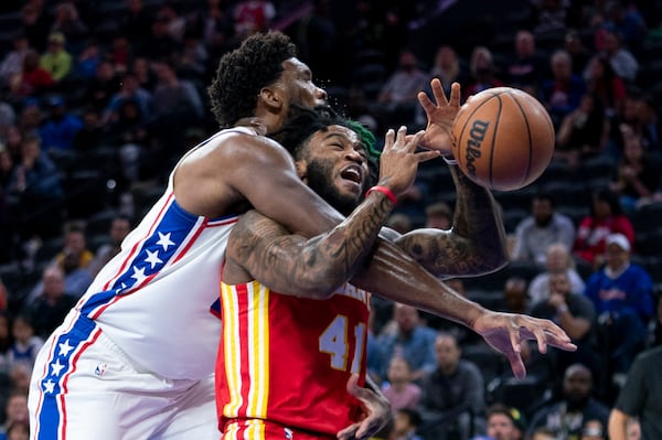 Atlanta Hawks' Saddiq Bey, right, reacts to a foul by Philadelphia 76ers' Joel Embiid, left, during the first half of a preseason NBA basketball game, Friday, Oct. 20, 2023, in Philadelphia. (AP Photo/Chris Szagola)