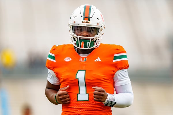 Miami quarterback Cam Ward (1) warms up before an NCAA college football game against Georgia Tech, Saturday, Nov. 9, 2024, in Atlanta. (AP Photo/Jason Allen)