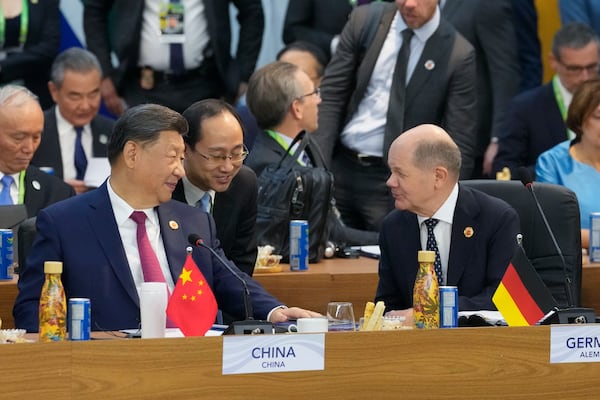 China's President Xi Jinping, left, talks with Germany's Chancellor Olaf Scholz during the G20 Summit leaders meeting in Rio de Janeiro, Monday, Nov. 18, 2024. (AP Photo/Eraldo Peres)