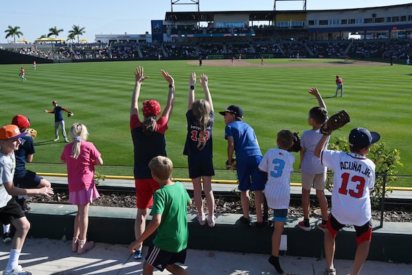 Young fans jockey for a ball at CoolToday Park in North Port, Florida, in 2024.