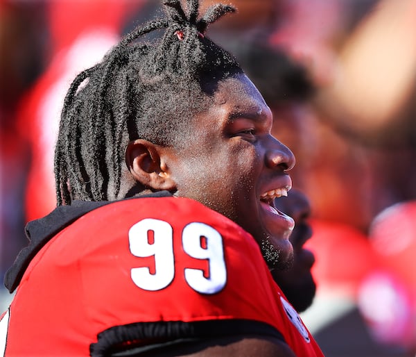 Georgia senior defensive lineman Jordan Davis is all smiles on the sidelines after getting to play a little offense on senior day.    “Curtis Compton / Curtis.Compton@ajc.com”