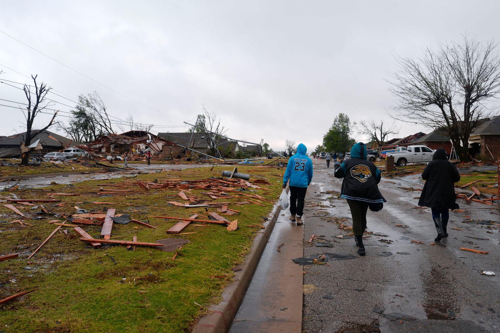 People look at damage to homes along SE 84 after a tornado moved through the area in Oklahoma City, Sunday, Nov. 3, 2024. (Bryan Terry/The Oklahoman via AP)