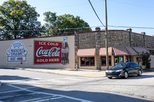 The owner of Manuel’s Tavern said the midtown Atlanta bar was vandalized early Wednesday. Among the damage: spray paint on the mural on a side of the building. (Brandon McKeown)