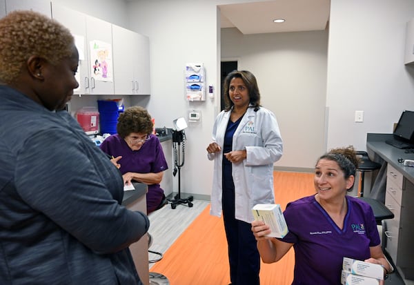 Dr. Anu Sheth (center) talks to her medical staff before the opening of the pediatric clinic at Pediatric Associates of Lawrenceville, Wednesday, August 9, 2023, in Lawrenceville. In June, 63,000 Georgia children lost Medicaid because the state did not receive the required application forms to keep them enrolled. Dr. Sheth's practice has already had parents show up for their child's appointment not knowing they were no longer insured and could not be seen until they re-apply. (Hyosub Shin / Hyosub.Shin@ajc.com)