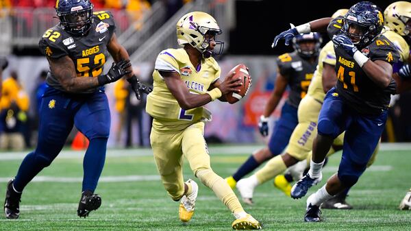 Alcorn State quarterback Felix Harper tries to evade the defense of North Carolina A&T linebacker Julian Monell (53) and defensive lineman Leon Smalls (41) during the second half of the Celebration Bowl Saturday, Dec. 21, 2019, at Mercedes-Benz Stadium in Atlanta.