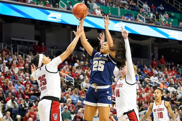 Georgia Tech guard Kara Dunn (25) shoots over North Carolina State guard Zoe Brooks (35) and forward Tilda Trygger (18) during an NCAA college basketball game in the quarterfinals of the Atlantic Coast Conference tournament Greensboro, N.C., Friday, March 7, 2025. (AP Photo/Chuck Burton)