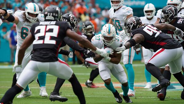 Miami Dolphins running back Myles Gaskin (37) charges through Falcons defenders including defensive tackle Ta'Quon Graham (95), cornerback Fabian Moreau (22), and linebacker Deion Jones (45), during the first half Sunday, Oct. 24, 2021, in Miami Gardens, Fla. (Hans Deryk/AP)