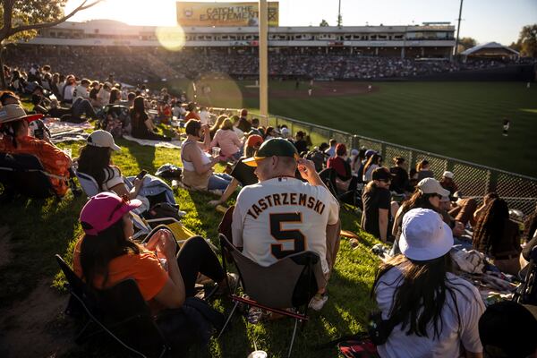 Mark Forsyth wears his Mike Yastrzemski jersey and A's hat in the outfield seating area during the San Francisco Giants game against the Sacramento Rivercats at Sutter Health Park in Sacramento Calif., on Sunday, March 23, 2025. The ballpark will be the home park for the Athletics this season after leaving Oakland. (Carlos Avila Gonzalez/San Francisco Chronicle via AP)