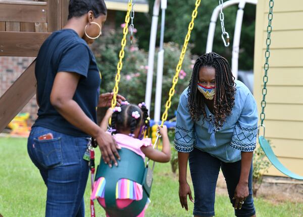 Linda James (right) regularly babysits her 2-year-old granddaughter, Ava Taylor, at her Montezuma home, to help her daughter Britney James (left). Linda James has mostly kept in isolation at her home for the past five months, ever since she left her Americus hair salon after hearing casual talk of infections being spread. Her Americus clinets keep calling, pressing her to come back to work, but James has Type 2 diabetes and high blood pressure, putting her at high risk if she became infected with the coronavirus. (Hyosub Shin / Hyosub.Shin@ajc.com)