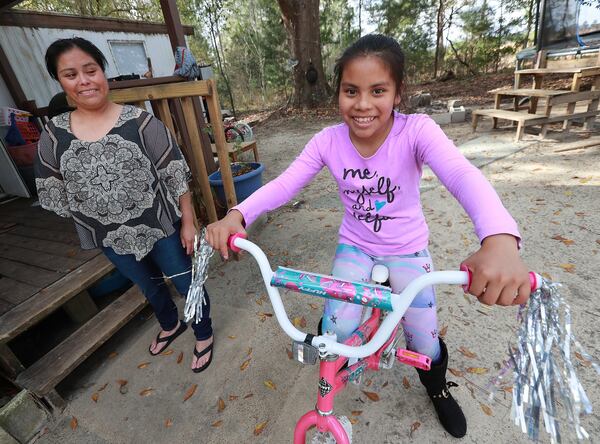 Vilma Carrillo, a Guatemalan woman seeking asylum in the United States, and her 12-year-old daughter Yeisvi. They were recently reunited after being separated for many months following Vilma’s arrest on the southwest border. They share a mobile home with other relatives in Vidalia. Curtis Compton/ccompton@ajc.com Curtis