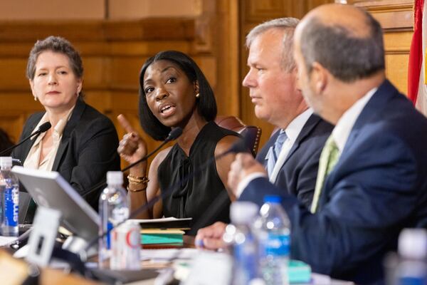 State Election Board member Janelle King (second from left) speaks during a September meeting regarding a dispute over comments fellow member Sara Tindall Ghazal (left) made on MSNBC. Ghazal said that King and two other board members have “some other motive” in making last-minute changes in the state's election rules. King then accused Ghazal of "creating a conspiracy." Arvin Temkar/AJC