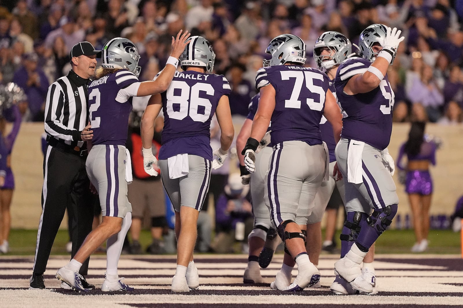 Kansas State tight end Garrett Oakley (86) celebrates with quarterback Avery Johnson (2) after scoring a touchdown during the first half of an NCAA college football game against Kansas Saturday, Oct. 26, 2024, in Manhattan, Kan. (AP Photo/Charlie Riedel)