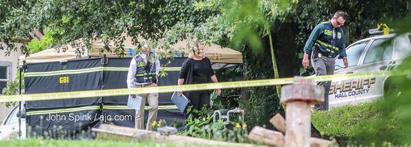 GBI and Hall County sheriff's deputies investigate after a man was killed when a pursuing deputy returned fire. JOHN SPINK / JSPINK@AJC.COM