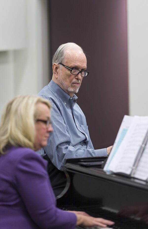 Frank Boggs, the founding director of the Georgia Festival Chorus, listens during April 18 choir rehearsals in Smyrna while accompanist Cathy Callaway Adams (left) plays. DAVID BARNES / DAVID.BARNES@AJC.COM