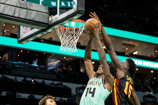 Atlanta Hawks center Clint Capela (15) blocks a shot attempt by Charlotte Hornets forward Moussa Diabate (14) during the first half of an NBA basketball game, Saturday, Nov. 30, 2024, in Charlotte, N.C. (AP Photo/Matt Kelley)