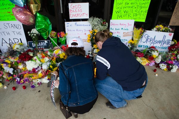 Allison Calhoun (left) and Brittany Bengert set up candles during a vigil Thursday night.