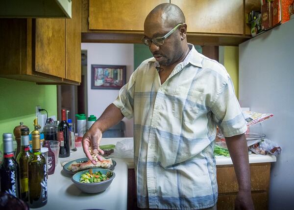 Simeon Gant prepares a salad for his dinner on Thursday, July 6, 2017. Gant gave up pork 20 years ago, then beef five years ago. He no longer cooks chicken at home but occasionally eats it when he's out. He's one of a growing number of people who are being called Reducetarians. (Hector Amezcua/Sacramento Bee/TNS)