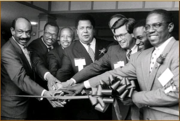 Atlanta Mayor Maynard Jackson (center) attends a ribbon cutting with Herman Russell (left), Egbert Perry (second from left) and other Atlanta business leaders in approximately 1990. Courtesy of Egbert Perry. 