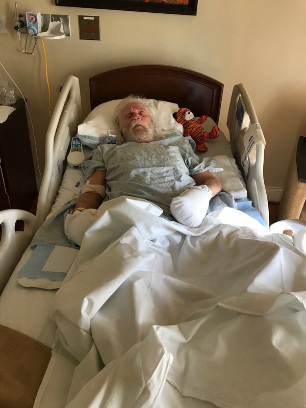 Ronald West at Tranquility Hospice at Cobb Hospital in March 2018. West, who had Alzheimer’s, suffered a head injury during an altercation with a caregiver at a Smyrna assisted living facility. The stuffed animal in his bed was a gift from his 10-year-old granddaughter, Ali. West died a few days after this photo of complications from his head injury. FAMILY PHOTO.