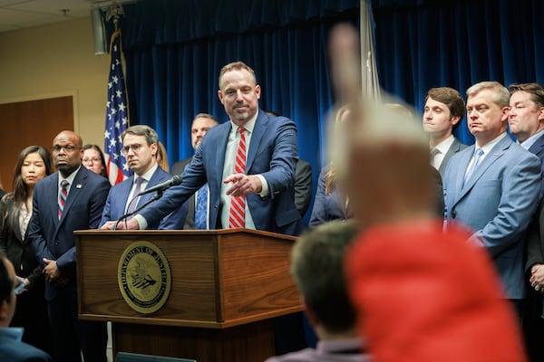 Assistant U.S. Attorney Joe Thompson, center, answers questions during a press conference at the Minneapolis federal courthouse, Wednesday, March 19, 2025, in Minneapolis, after a jury found the alleged ringleader of a massive pandemic fraud case guilty on all counts Wednesday for her role in a scheme that federal prosecutors say stole $250 million from a program meant to feed children in need. (Kerem Yücel/Minnesota Public Radio via AP)