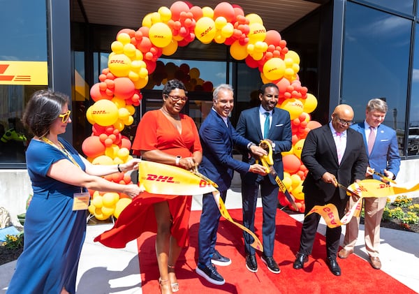 Executives and officials including Atlanta Mayor Andre Dickens cut the ribbon at the DHL Express Hub official grand opening in Atlanta on Thursday, July 6, 2023. (Arvin Temkar / arvin.temkar@ajc.com)