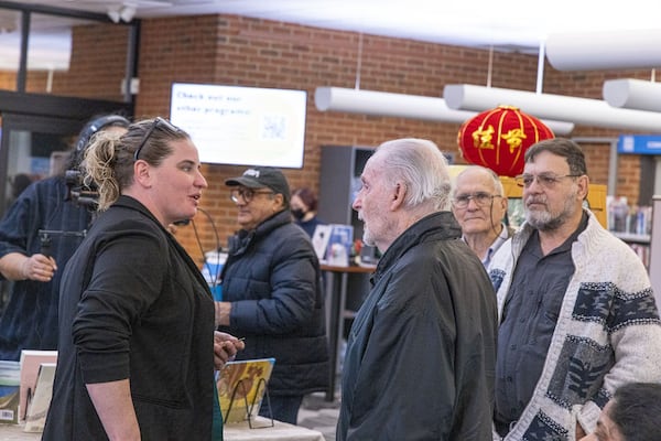 The photography club includes esteemed retired NASA photographer Chuck Rogers. He talks with Amanda Gardner during the exhibits grand opening. Photo courtesy of David Dunagan