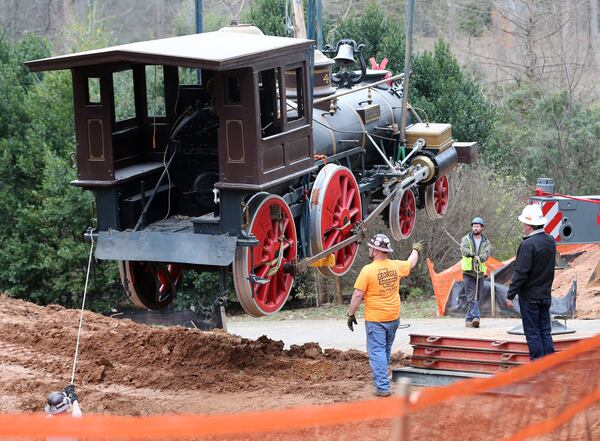 Workers haul the 53,000 pound Texas out of its home at the Cyclorama in Grant Park on Dec. 21, 2015. The locomotive began a trip that day that eventually brought it to the Atlanta History Center. Ben Gray / bgray@ajc.com