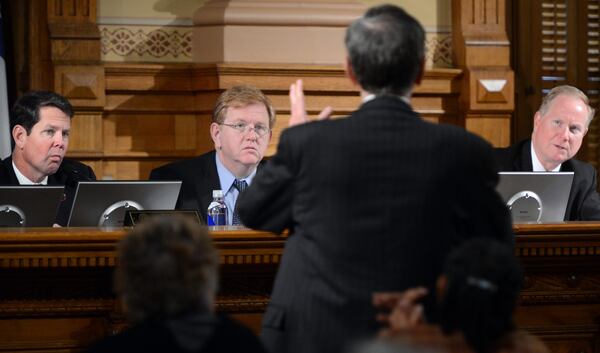 Lawyer David Walbert (foreground) speaks to State Election Board Members (from left) Brian Kemp, Chairperson, David J. Worley and L. Kent Webb during a meeting at The Georgia State Capitol in Atlanta on Tuesday, November 27, 2012.