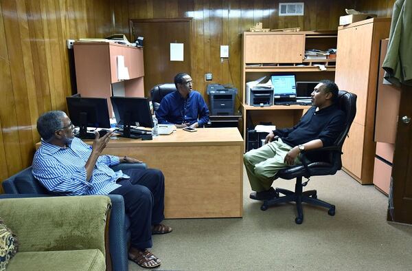 Omar Shekhey (right), executive director for the Somali American Community Center in Clarkston, talks with Abdi Guray (left) and Clarkston City Council member Ahmed Hassan at Hassan's office in Campus Plaza in Clarkston on Thursday, April 13, 2017. HYOSUB SHIN / HSHIN@AJC.COM