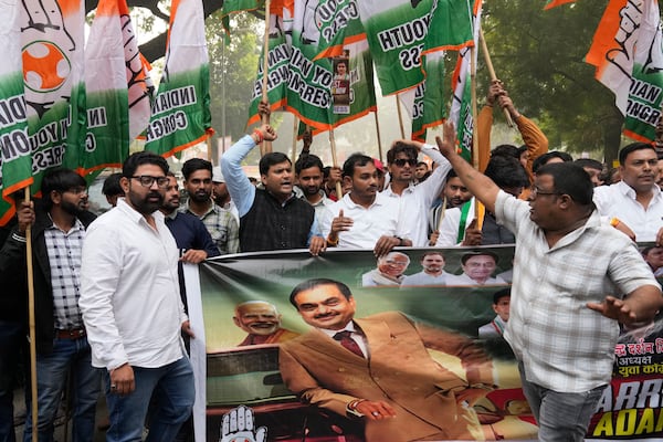 India's opposition Congress party members shout slogans during a protest against Indian billionaire Gautam Adani and Indian Prime Minister Narendra Modi after Adani was indicted by U.S. prosecutors for bribery and fraud, in New Delhi, India, Monday, Nov. 25, 2024. (AP Photo/Manish Swarup)