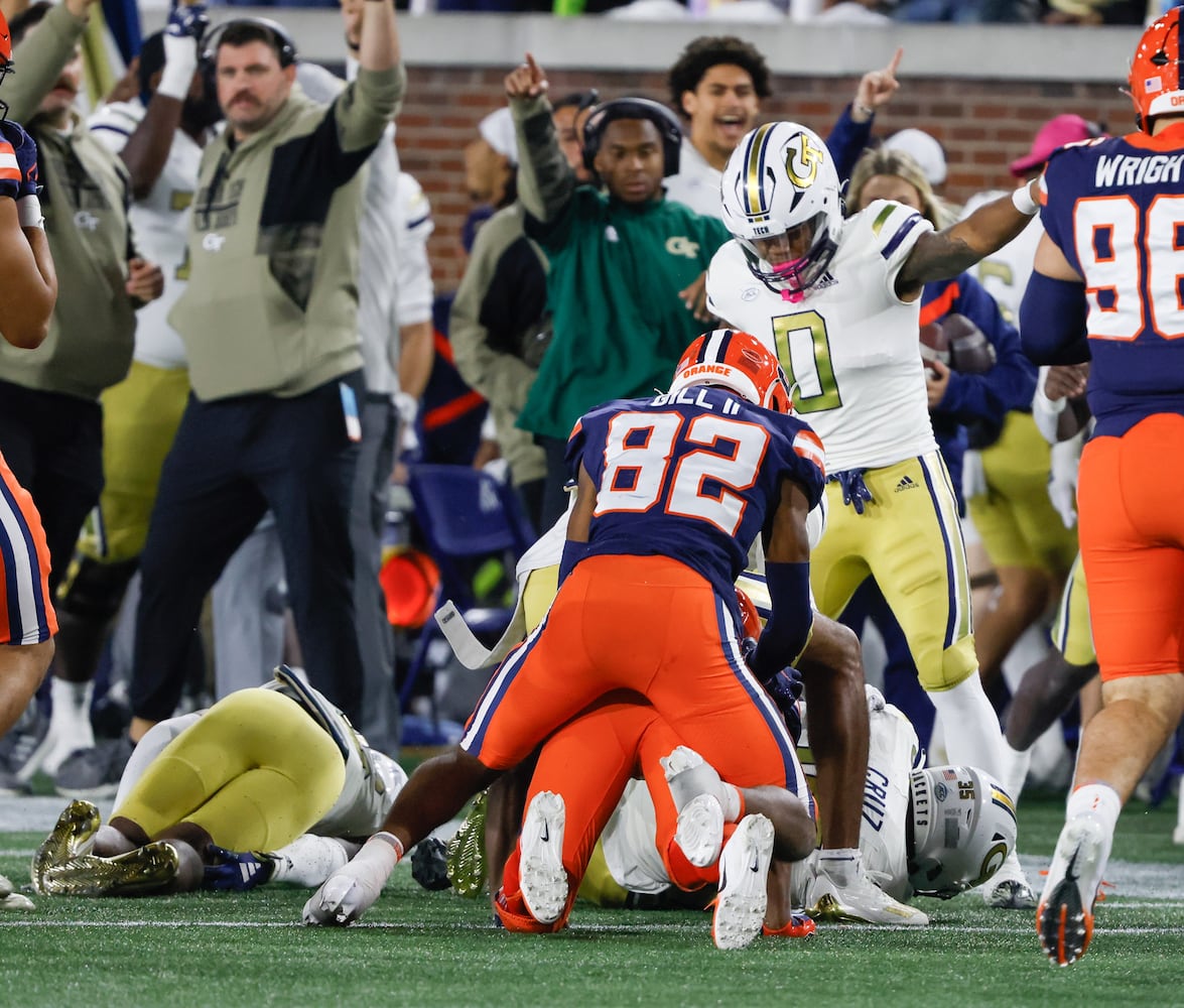 On the second half kickoff, Syracuse Orange wide receiver Darrell Gill Jr. (82) fumbled, forced by Georgia Tech Yellow Jackets linebacker Paul Moala (13) and recovered by Georgia Tech Yellow Jackets linebacker Jacob Cruz (35) during an NCAA college football game between Georgia Tech and Syracuse in Atlanta on Saturday, Nov. 18, 2023.  Georgia Tech won, 31 - 22. (Bob Andres for the Atlanta Journal Constitution)