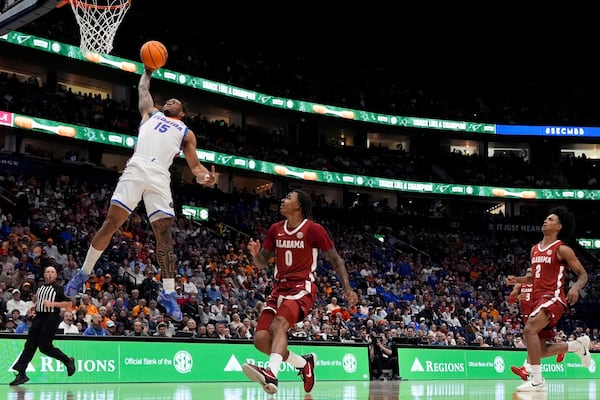 Florida guard Alijah Martin (15) dunks on Alabama guard Labaron Philon (0) during the second half of an NCAA college basketball game in the semifinal round of the Southeastern Conference tournament, Saturday, March 15, 2025, in Nashville, Tenn. (AP Photo/George Walker IV)